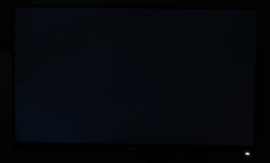 Monitor displaying black in a dark room