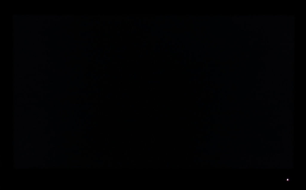 Monitor displaying black in a dark room