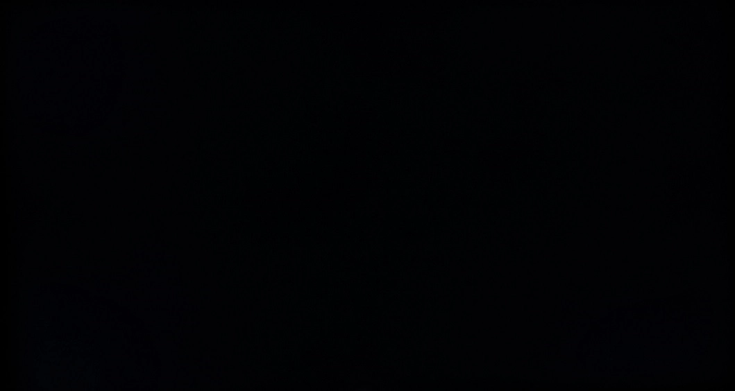 Monitor displaying black in a dark room