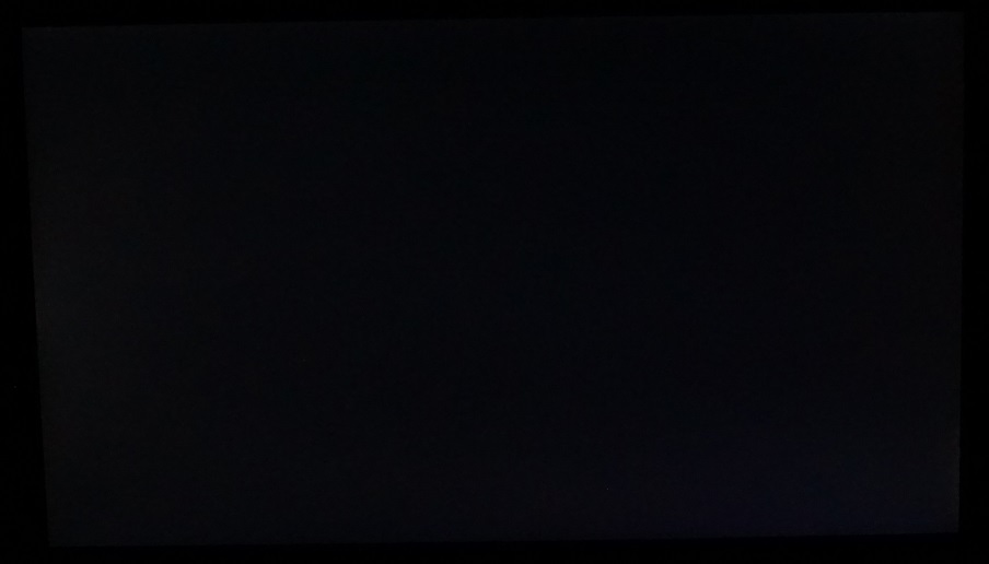 Monitor displaying black in a dark room