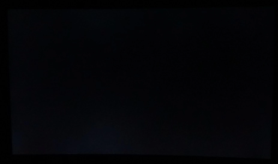 Monitor displaying black in a dark room