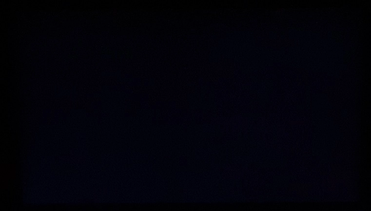 Monitor displaying black in a dark room