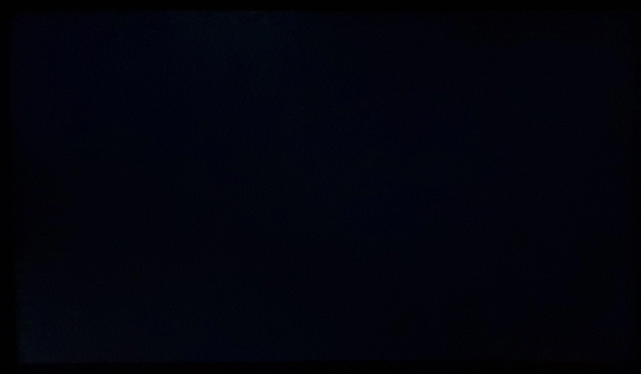 Monitor displaying black in a dark room